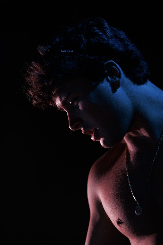 Portrait of T-MØTION in dark blue and red lighting