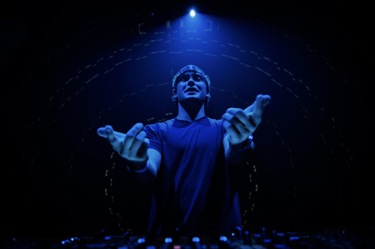 T-MØTION performing under blue stage lights